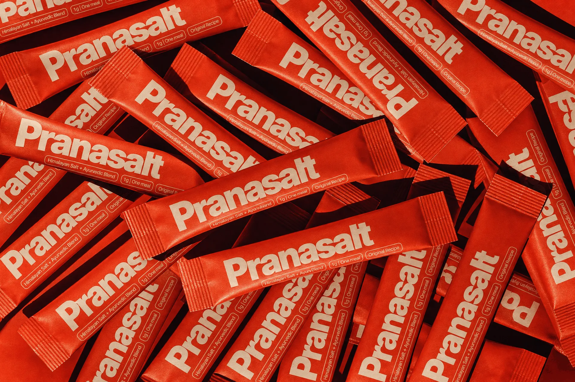 A pile of red Pranasalt stick-pack sachets